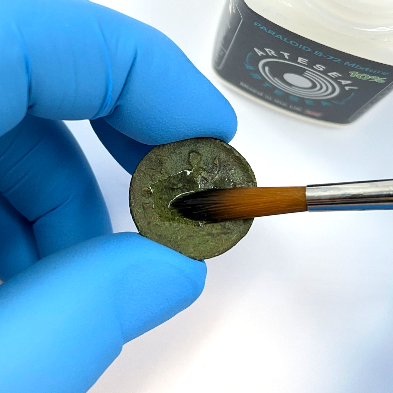 Brushing coin with ArteSeal